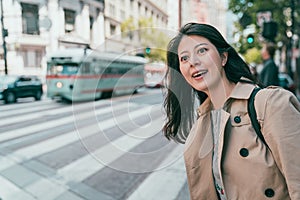 Woman smiling and feeling curious while traveling