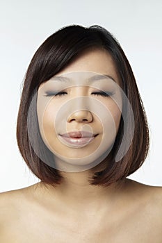 Woman smiling with her eyes closed. Conceptual image