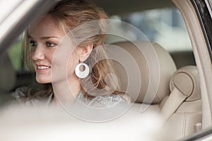 Woman smiling in her new car