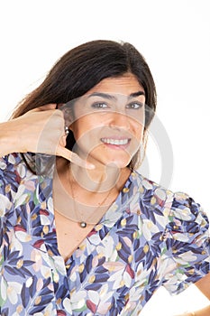 Woman smiling make phone sign gesture call me back with hand and fingers like talking on phone cell