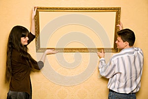 Woman and smiling man hang up on wall picture