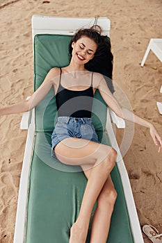 woman smiling ocean beach sun lying sea resort sand sunbed lifestyle