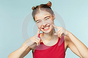 Woman smiling with perfect smile on the blue studio background