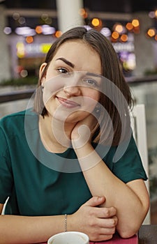 Woman smiling with perfect smile in mall and looking at camera. Vertical image.