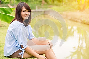 Woman smiling with perfect smile and white teeth in park and looking at camera