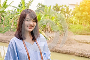 Woman smiling with perfect smile and white teeth in park and looking at camera