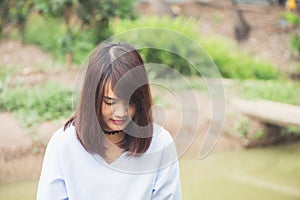 Woman smiling with perfect smile and white teeth in park and looking at camera