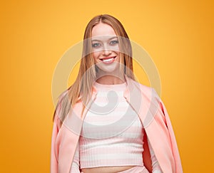 Woman smiling in pink jacket in studio