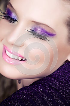 Woman smiling with purple eyeshadow