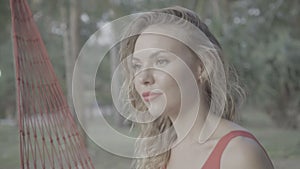 Woman smiling while relaxing on the hammock at the beach