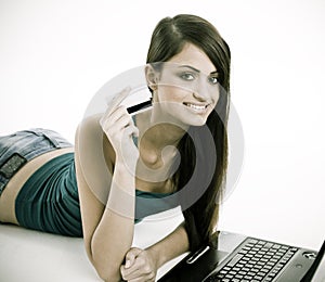 Woman smiling showing the credit card