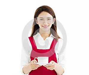 Woman smiling and showing cup of coffee