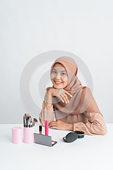 Woman smiling while sitting after do some make up