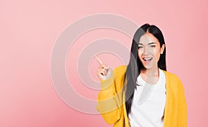 Woman smiling standing pointing finger out