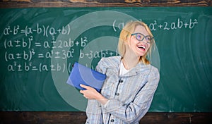 Woman smiling teacher hold book stand front chalkboard. Recommendation for college concept. Request letter