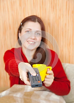 Woman smiling with TV remote