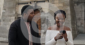 Woman smiling, using phone and ignoring boyfriend.