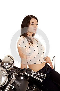 Woman smirking sitting on a motorcycle