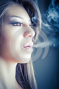 Woman smokes in the dark