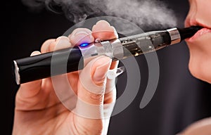 Woman smoking with electronic cigarette