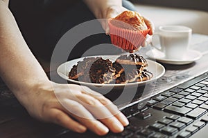 Woman snacking with sweets at workplace