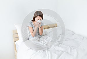 Woman sneeze on the bed