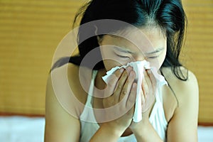 Woman sneeze on bed