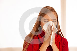 Woman sneezes holding a handkerchief nasal photo