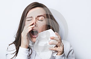 Woman sneezes in a napkin photo