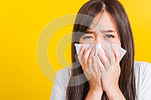 Woman sneezing sinus using towel to wipe snot from nose