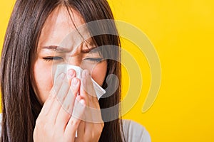 Woman sneezing sinus using towel to wipe snot from nose