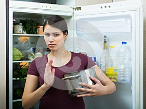 Woman sniffing at foul food