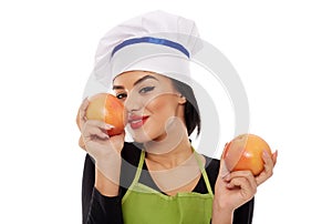 Woman sniffing perfumed grapefruit