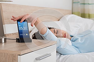 Woman Snoozing Alarm On Mobile Phone