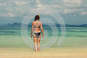 Woman with snorkel on the beach