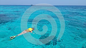 Woman snorkeling in the blue sea