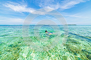 Woman snorkeling in caribbean on coral reef tropical turquoise blue water. Indonesia Wakatobi archipelago, marine national park,