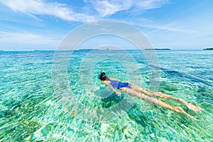 Woman snorkeling in caribbean on coral reef tropical turquoise blue water. Indonesia Wakatobi archipelago, marine national park,