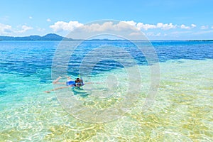 Woman snorkeling in caribbean sea, turquoise blue water, tropical island. Indonesia Banyak Islands Sumatra, tourist diving travel