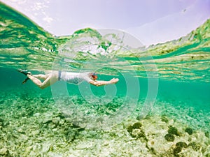 woman snorkeling in clear tropical sea