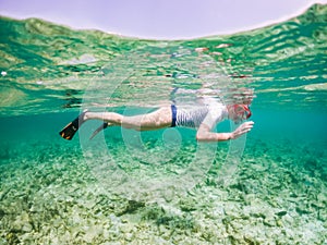 woman snorkeling in clear tropical sea