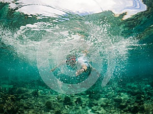 woman snorkeling in clear tropical sea