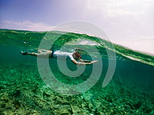 woman snorkeling in clear tropical sea