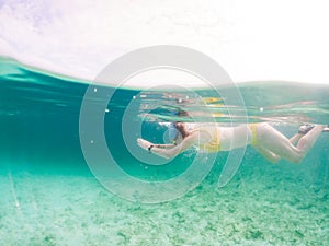 woman snorkeling in clear tropical sea