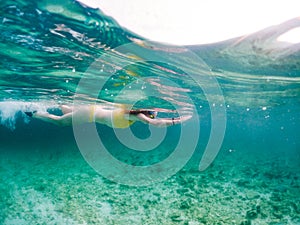 woman snorkeling in clear tropical sea