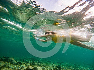 woman snorkeling in clear tropical sea