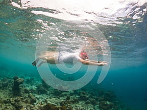 woman snorkeling in clear tropical sea