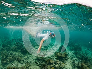 woman snorkeling in clear tropical sea