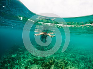 woman snorkeling in clear tropical sea