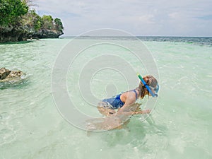 Woman snorkeling on coral reef tropical caribbean sea, turquoise blue water. Indonesia Banda archipelago, Moluccas Maluku, tourist